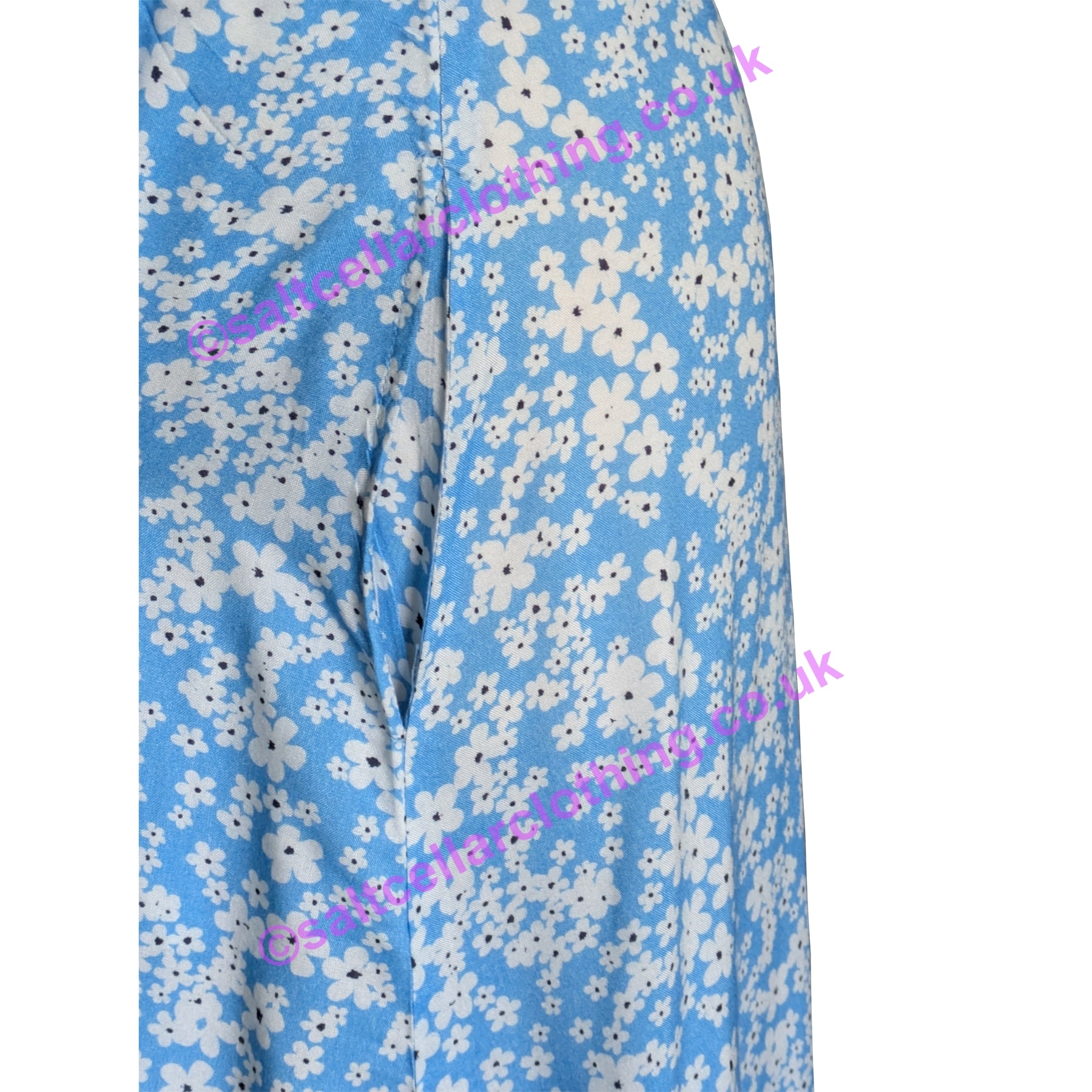 Close up view of the hip pocket on a Mudd & Water womens Alyssa dress in blue with a white floral pattern on a white background
