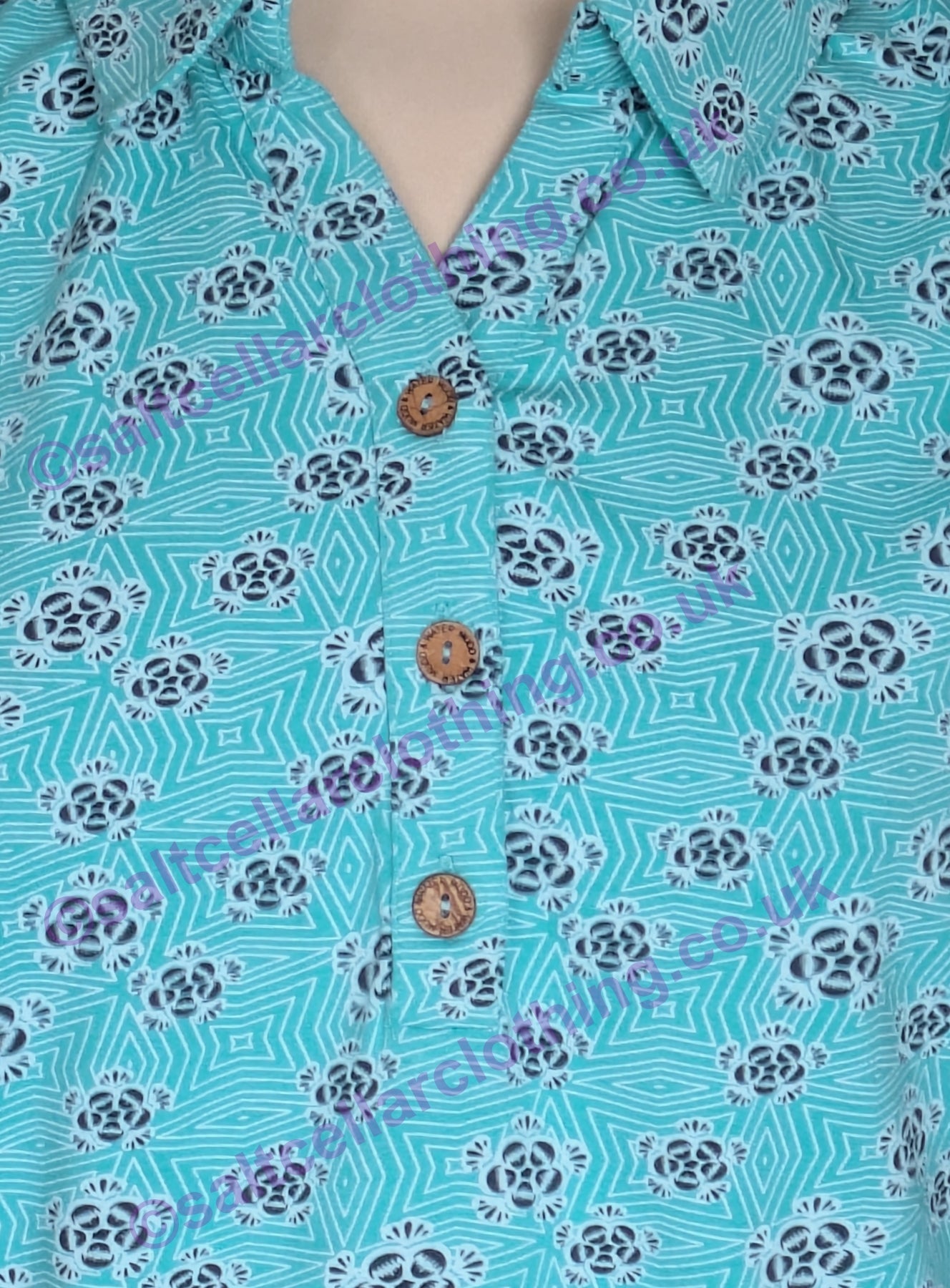 Close-up of a Mudd & Water womens turquoise Alice Top with a geo floral pattern and brown buttons.