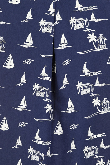 Closeup of the front pleat of a womens Mudd & Water Sunrise Blouse fabric in navy with a tropical nautical pattern