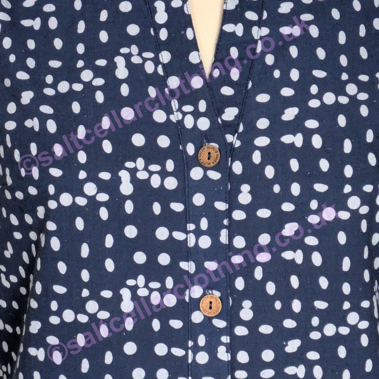 Close-up of a womens Mudd & Water Sunrise Blouse navy fabric with white dot pattern and wooden buttons