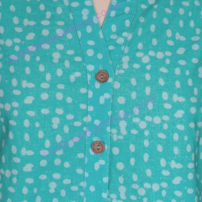 Close-up of a Mudd & Water turquoise Sunrise blouse with a polka dot pattern and wooden buttons.
