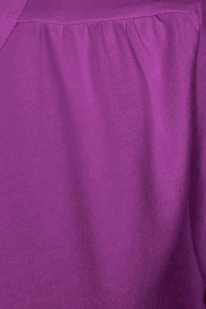 Close-up of gathered fabric on the shoulder of a womens Muddd & Water 'Aqua' t-shirt in Aster Purple