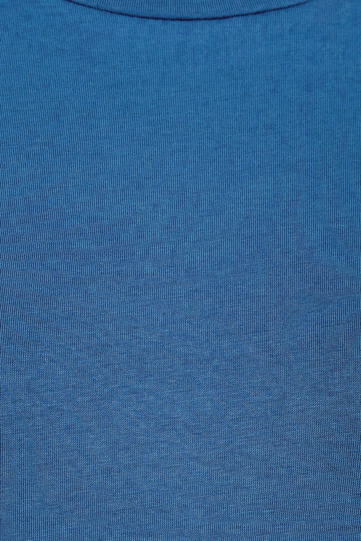 Close-up of a Mudd & Water womens organic cotton Essential Top in a Teal blue fabric texture