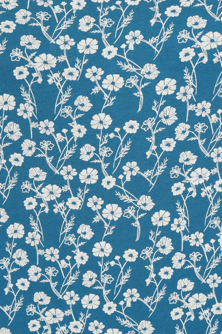Mudd & Water women's Fern top in Teal Blue with white floral Meadow pattern.