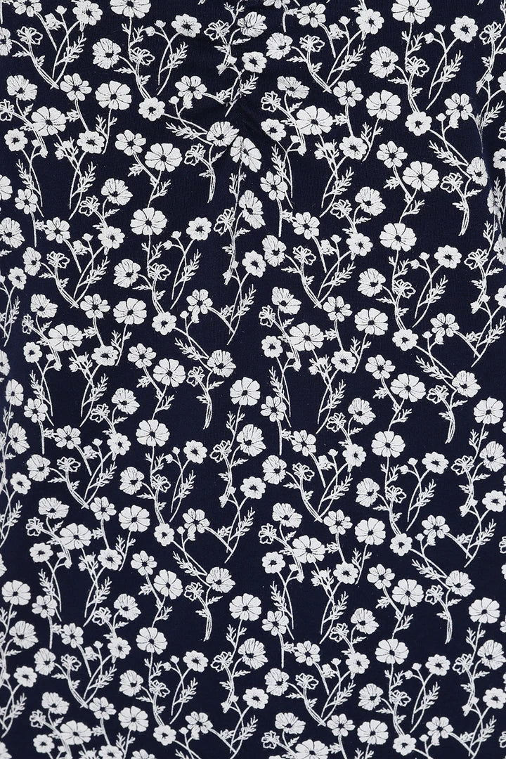 Mudd & Water women's Florina Dress in Navy with a white meadow floral print, V-neckline and gathered sleeve cuffs.
