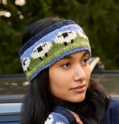 Woman wearing a Pachamama knitted headband with sheep pattern outdoors