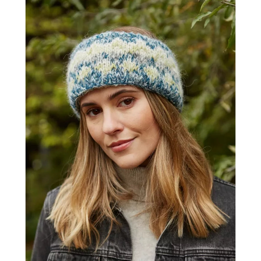 Woman wearing a green geometric pattern Pachamama Totnes headband with an outdoor background