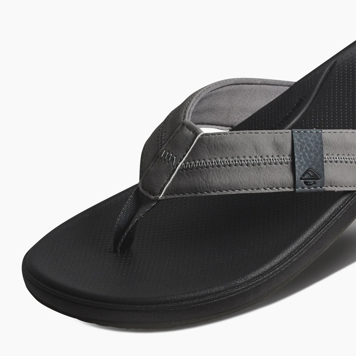 Reef mens cushion flip flops in black with soft straps and contoured footbed for comfort