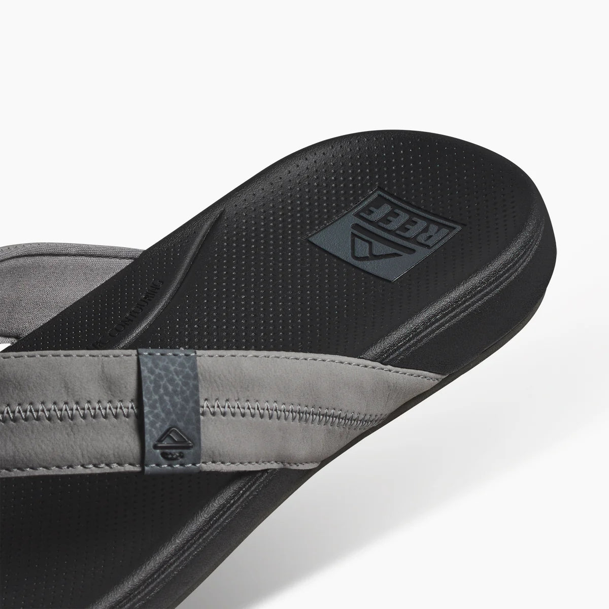 Reef mens cushion flip flops featuring a comfortable footbed and stylish strap design