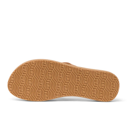 Bottom sole view of womens Reef Baja Sands flip flops in Almond brown with Reef logo and wave shaped outsole grips