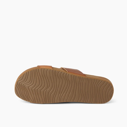 Bottom outsole view of a womens Reef Cushion Vista faux leather double strap sandal in Espresso Duo brown, with swell shaped grips.