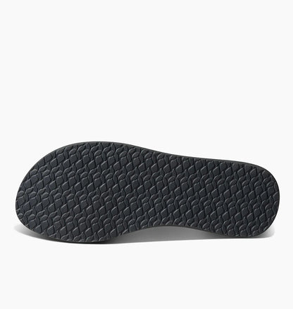 Black textured sole of Reef womens Cushion Breeze flip flops showing non-slip grip pattern