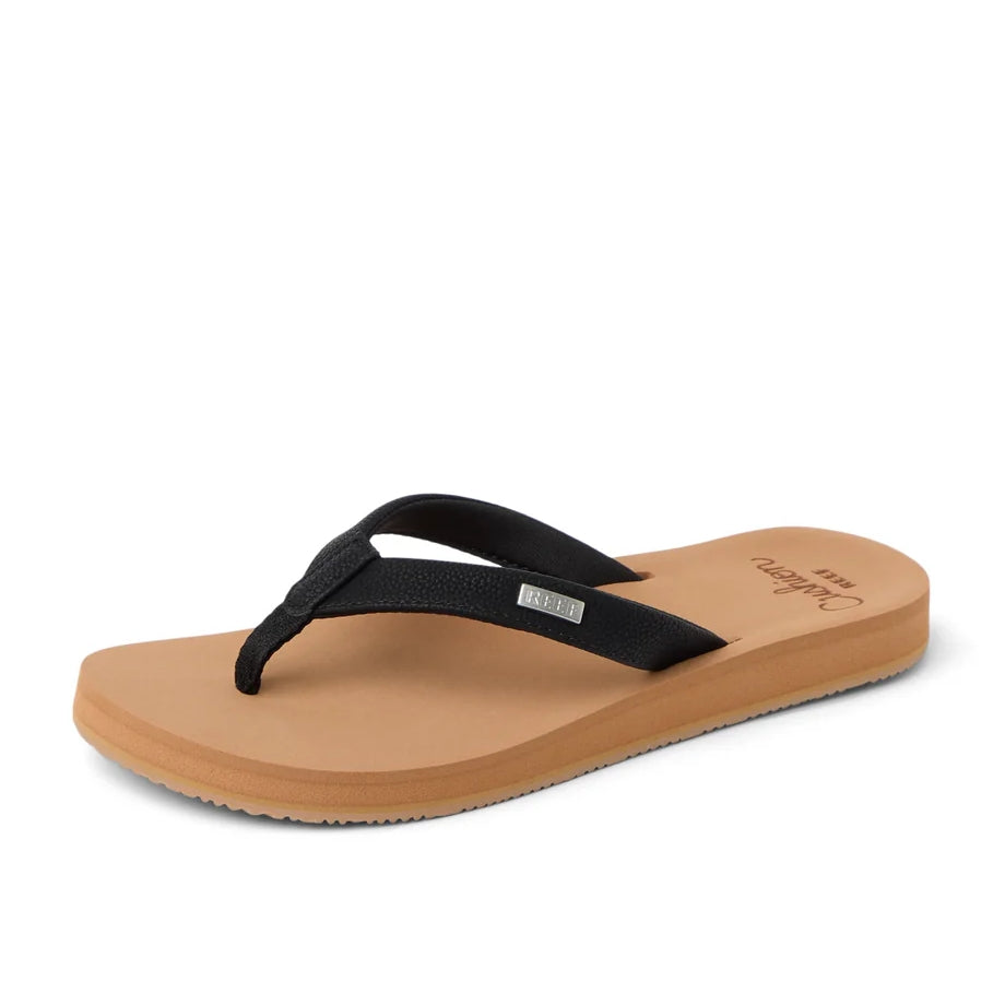 Front view of womens Reef Baja Sands flip flops in black/tan with logo label on the strap.