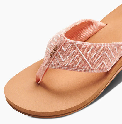 Reef womens peach flip flops with textured fabric straps and cushioned tan sole