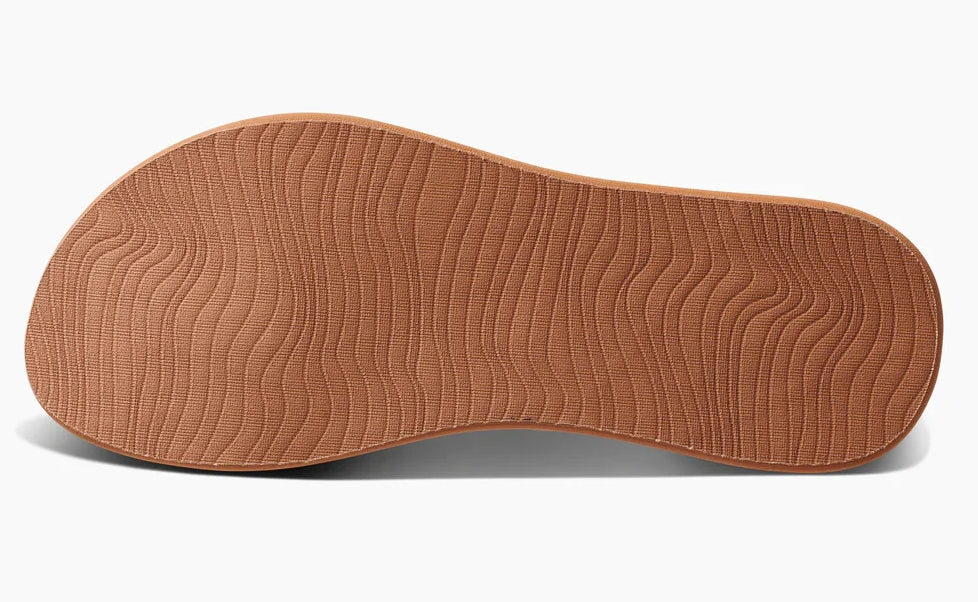 Reef womens peach flip flops showing textured brown sole for traction and comfort