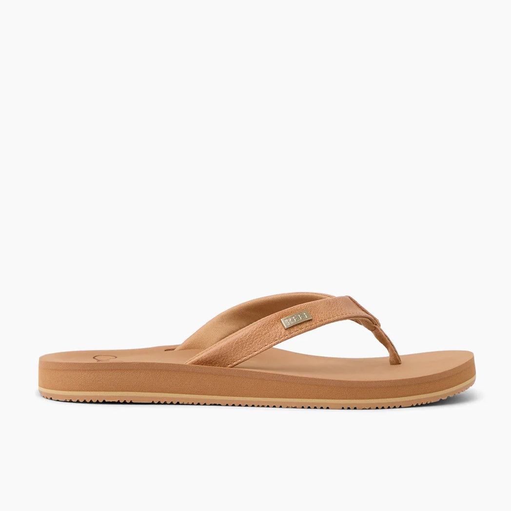 Side view of womens Reef Baja Sands flip flops in Almond brown with gold logo label on the strap.