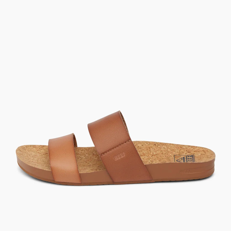 Side view of a womens Reef Cushion Vista faux leather double strap sandal in Espresso Duo, with cork footbed.
