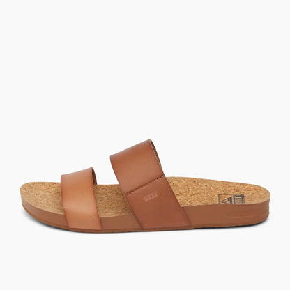 Side view of a womens Reef Cushion Vista faux leather double strap sandal in Espresso Duo, with cork footbed.