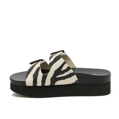 Side view of womens Rocket Dog Esti Plus slip on platform sandals, with two black and white zebra print straps