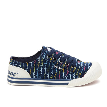 Side view of Rocket Dog women's Jazzin Radio canvas lace up trainers in navy blue with a multicolour striped stitching pattern and white accents.