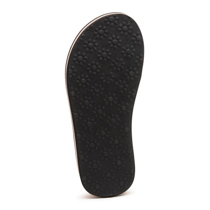 Bottom outsole view of a women's Rocket Dog Monica Leon flip flop, in black with flower pattern grips.