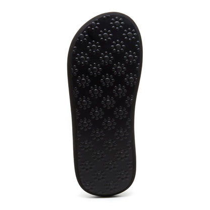 Bottom outsole view of a womens Rocket Dog Spotlight Monroe flip flop in black with a flower print grip pattern.
