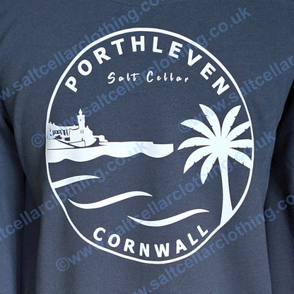 A close-up view of a Petrol blue unisex crewneck sweatshirt, featuring a large white circular graphic print that reads 'PORTHLEVEN Salt Cellar CORNWALL' with a harbourside clocktower, palm tree, and waves.