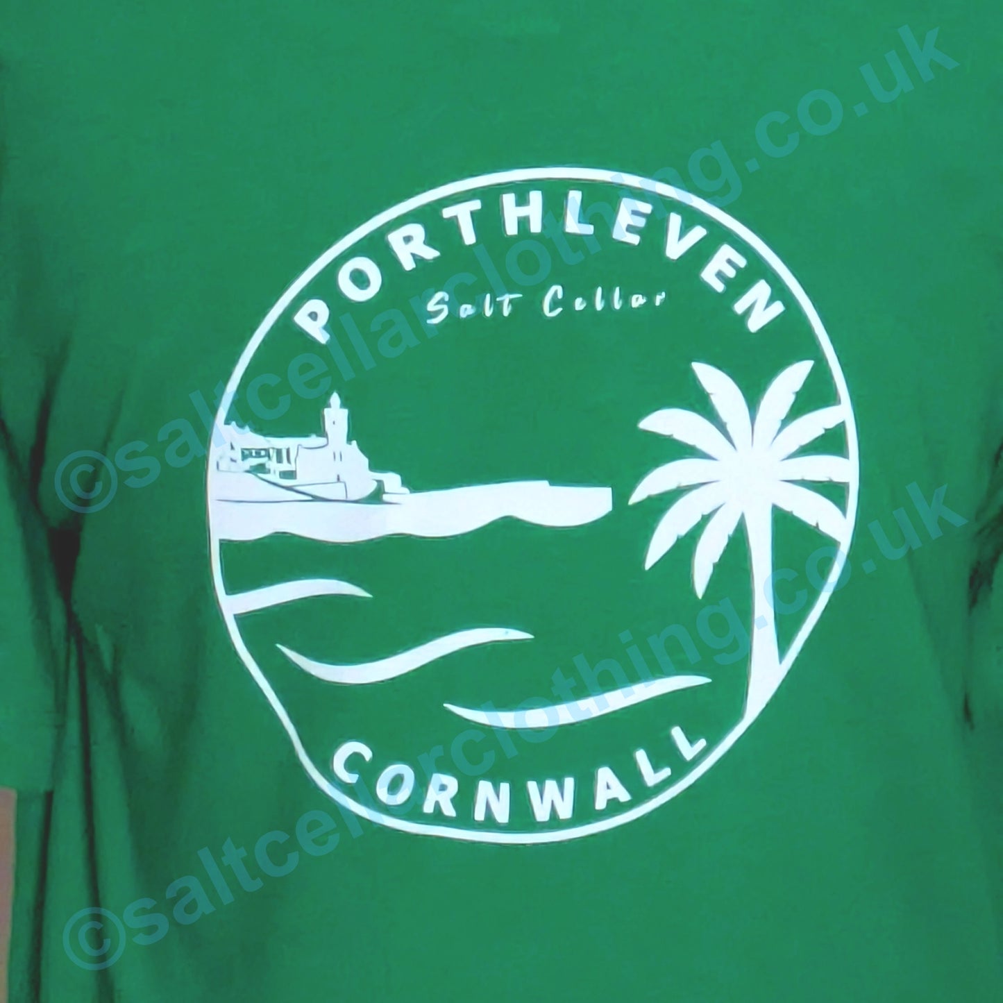 Green kids t-shirt with white graphic design featuring 'Porthleven Cornwall' text and coastal scene.