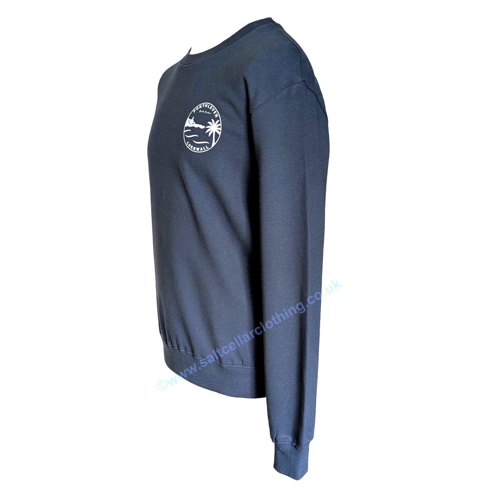 A Petrol blue unisex crewneck sweatshirt shown from the side, featuring a small white circular graphic print that reads 'PORTHLEVEN Salt Cellar CORNWALL' with a harbourside clocktower, palm tree, and waves.