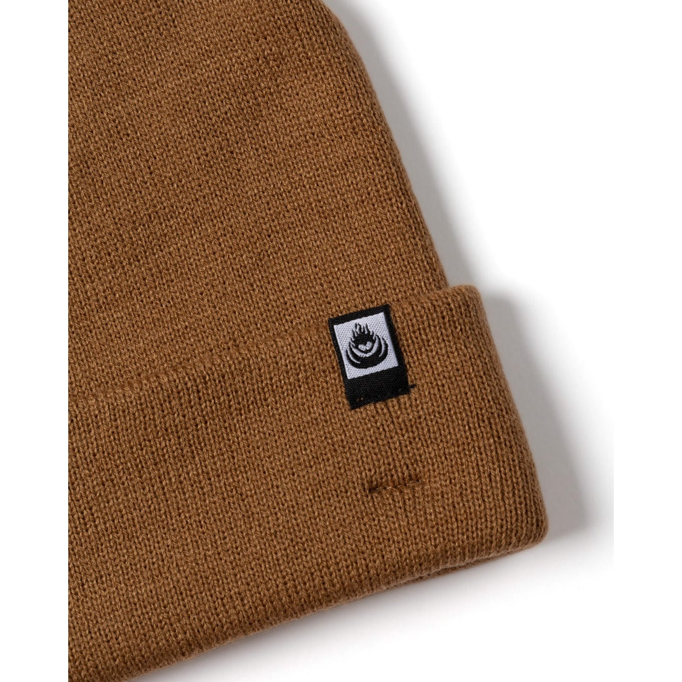 Brown knit Saltrock beanie with a logo tag on a white background