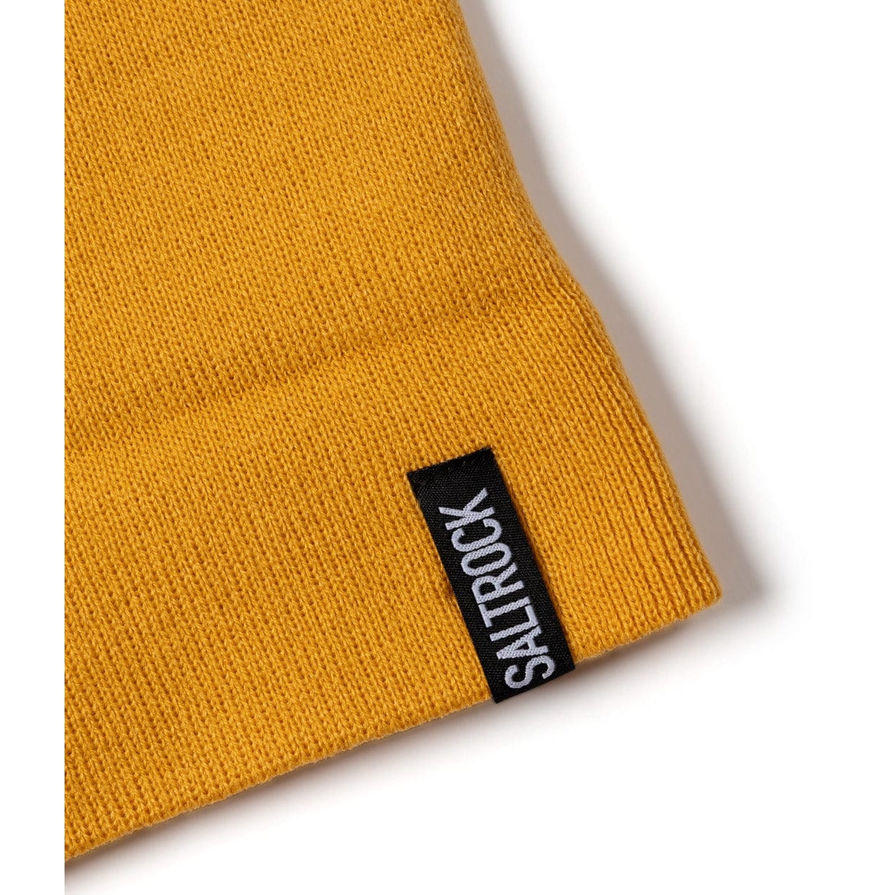 Yellow knit beanie with a black 'Saltrock' label on a white background
