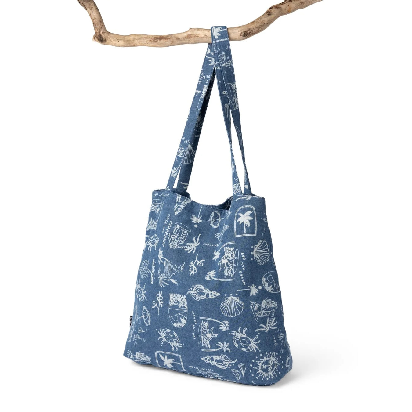 Back view of a Saltrock Island Life shopper bag in denim blue with a white tropical seaside print.