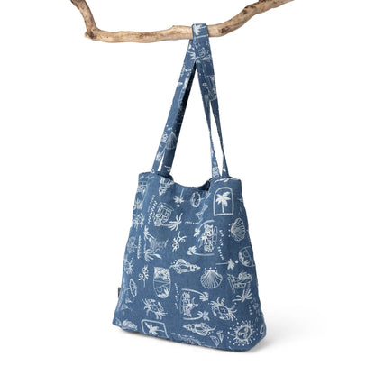 Back view of a Saltrock Island Life shopper bag in denim blue with a white tropical seaside print.