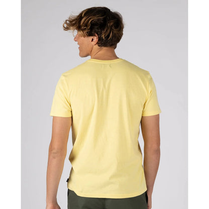 Back view of a man wearing a Saltrock short sleeve Essential t-shirt in light yellow with small chest logo with dark green shorts