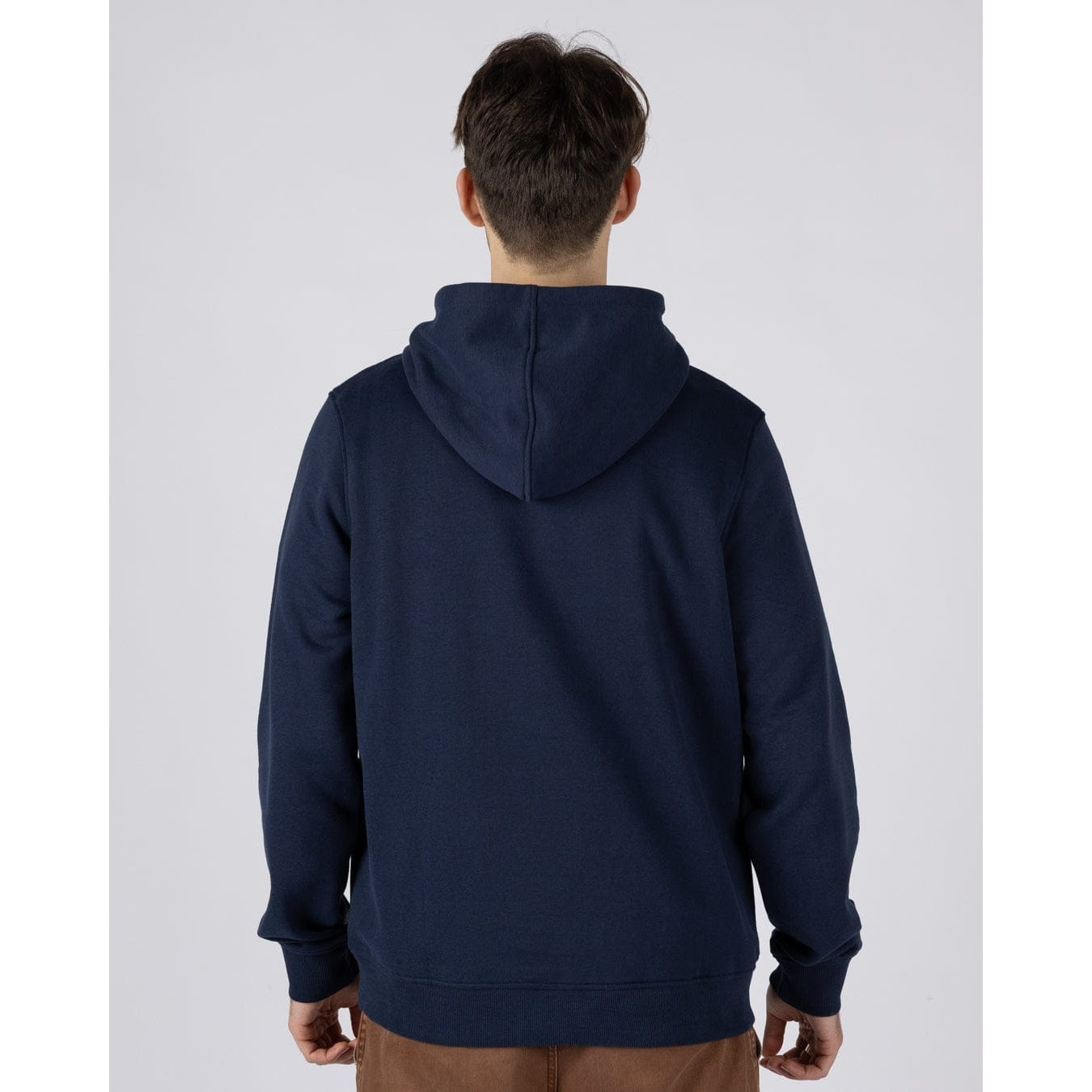 Back view of a man wearing a navy blue Saltrock Tribal Stripe pop hoodie with multicolour stripe print and logo across the chest
