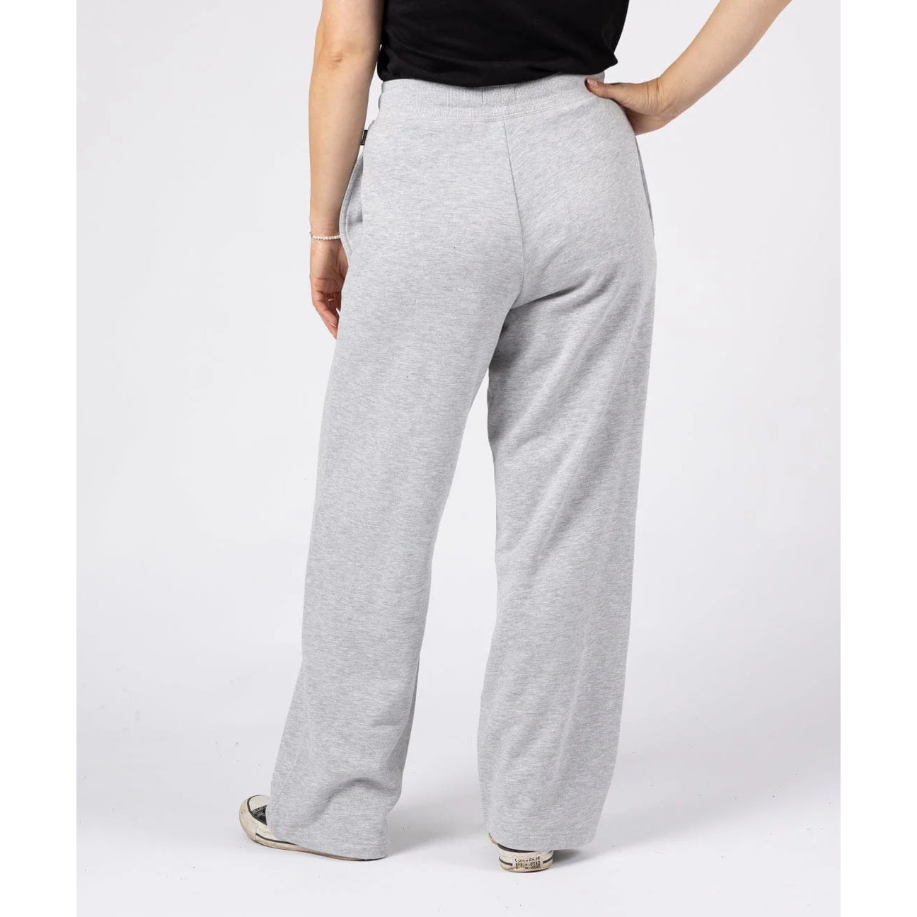 Back view of a woman wearing a pair of Saltrock sweat trousers in grey with drawstring waist.