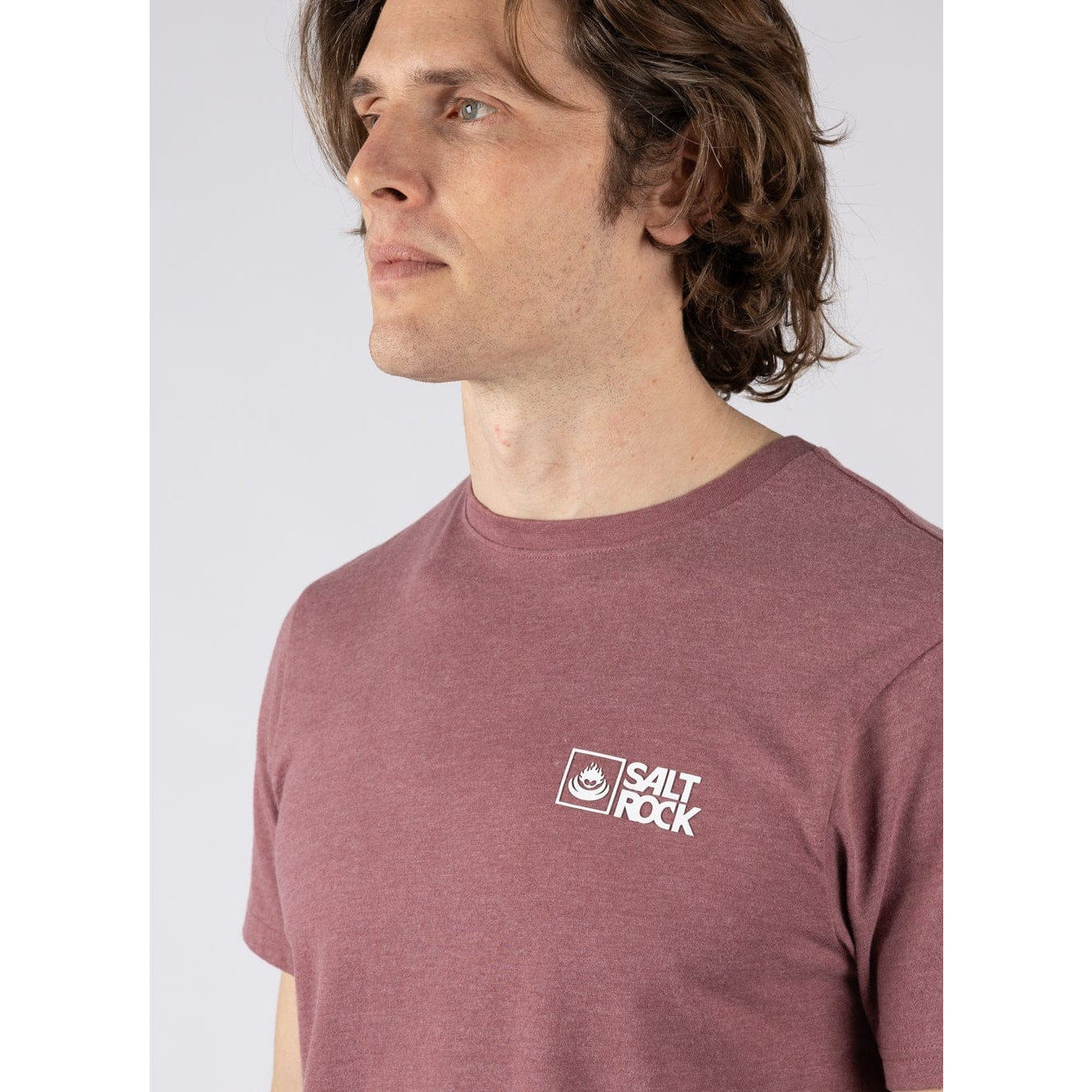Close-up view of a man wearing a Saltrock crew neck short sleeve Essential t-shirt with a white logo printed on the chest