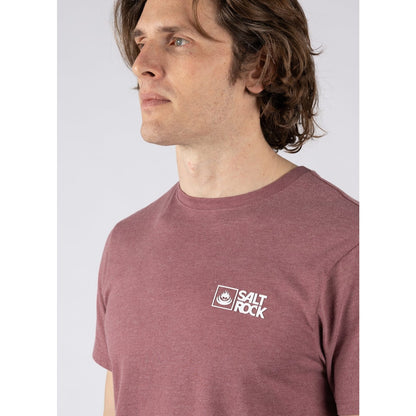 Close-up view of a man wearing a Saltrock crew neck short sleeve Essential t-shirt with a white logo printed on the chest