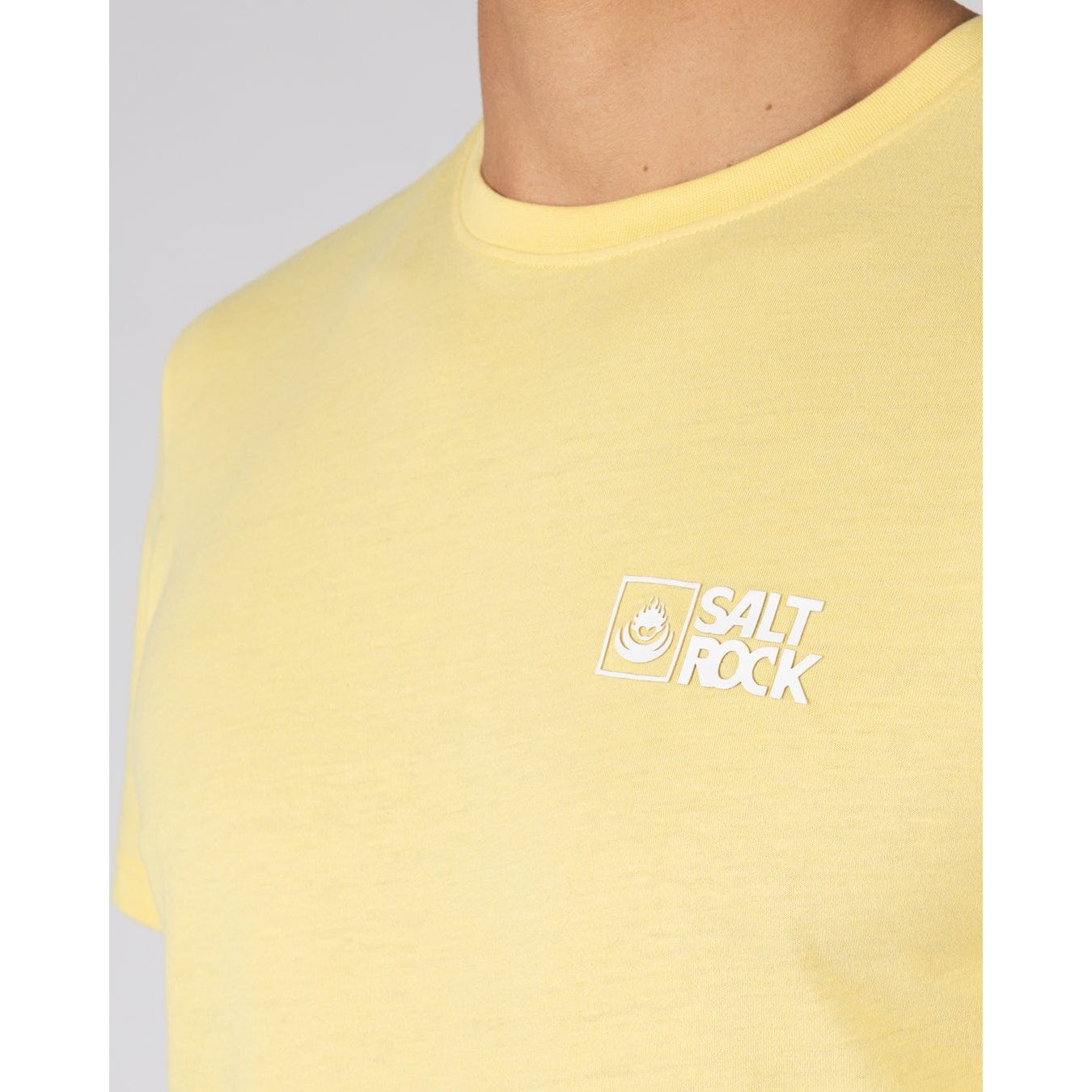 Close-up view of the chest logo on a Saltrock mens short sleeve crew neck Essential t-shirt in light yellow