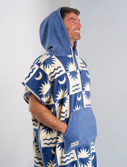 Saltrock changing towel robe blue with sun and wave pattern worn by smiling man with hood