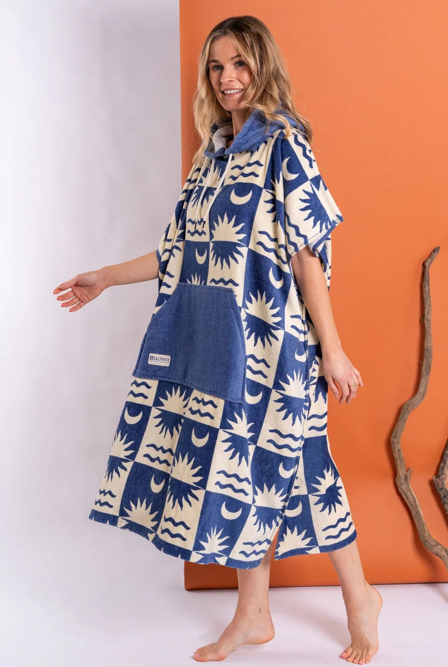 Saltrock changing towel robe blue with sun and wave patterns worn by woman on orange background