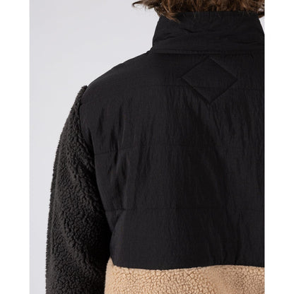 Close-up of the back shoulder of a men's Saltrock Rafe fleece in black and beige with a mix sherpa and nylon fabric