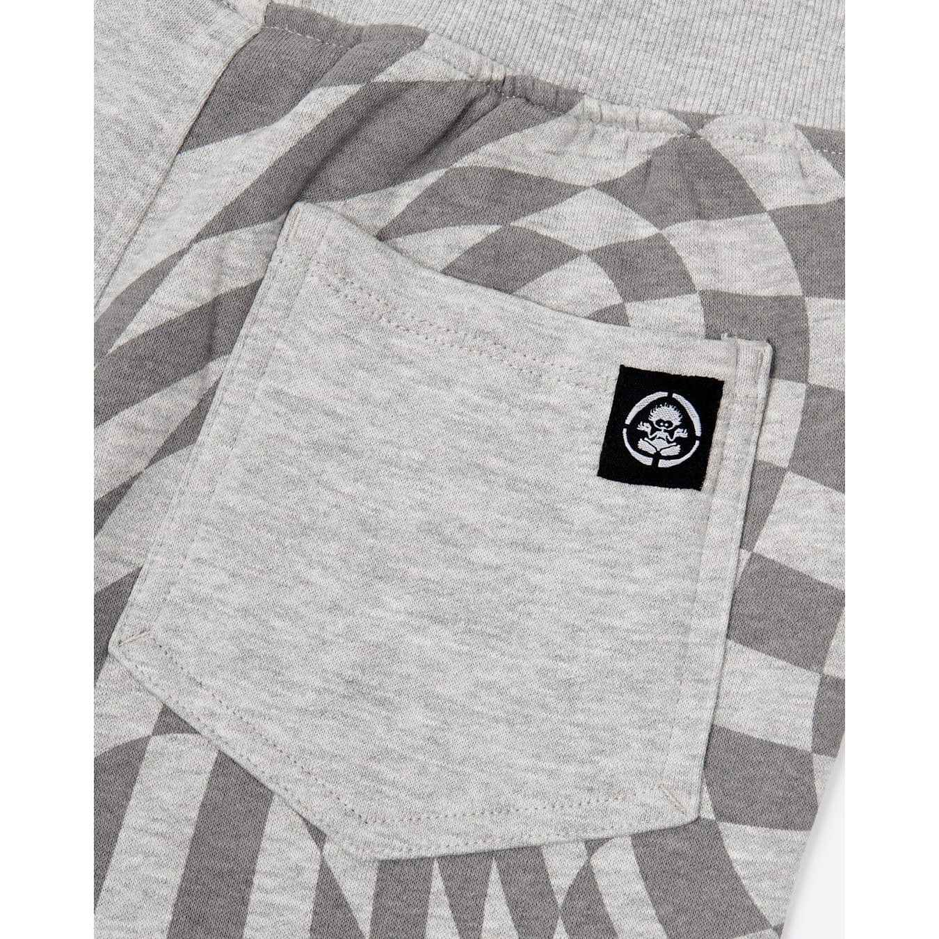 Close-up view of the back pocket on a pair of kids Saltrock Rip It jogger sweat trousers in grey with a geometric print on one leg