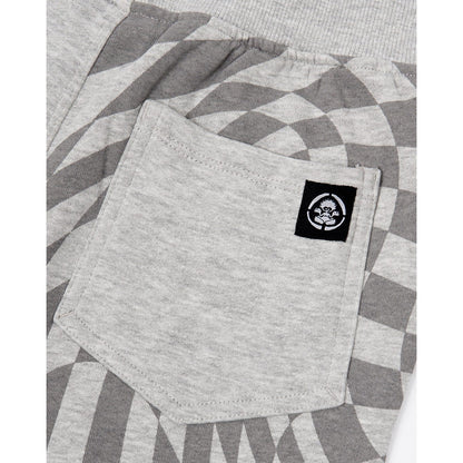 Close-up view of the back pocket on a pair of kids Saltrock Rip It jogger sweat trousers in grey with a geometric print on one leg