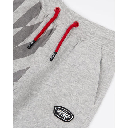 Close-up view of the drawcord waist on a pair of kids Saltrock Rip It jogger sweat trousers in grey with a geometric print on one leg