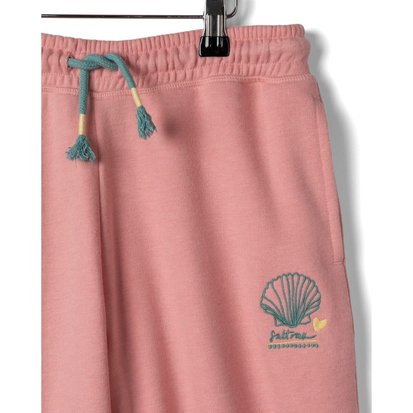 Close-up view of the drawstring waist of a pair of Saltrock kids Norie jogger trousers in pink