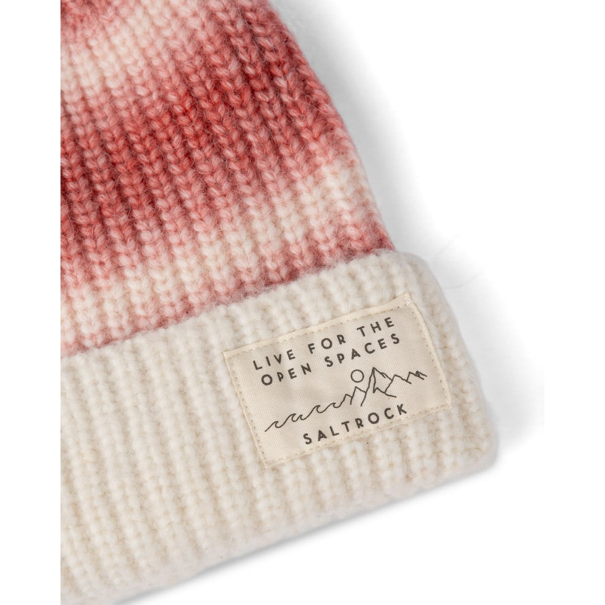 Close-up view of the turnup hem and logo label of a womens Saltrock Alba knitted beanie bobble hat in pink and cream.