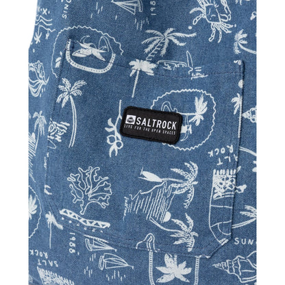 Close-up view of the front pocket with logo patch on a Saltrock Island Life shopper bag in denim blue with a white tropical seaside print.