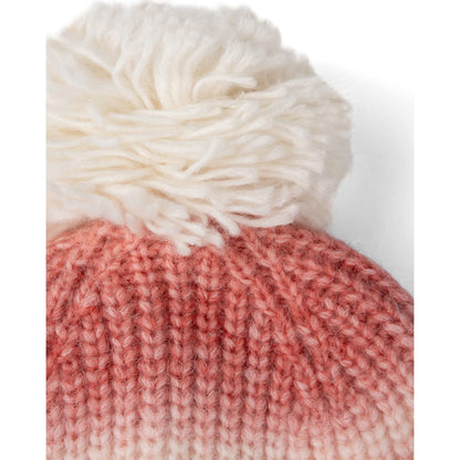 Close-up view of the top pom pom bobble on a womens Saltrock Alba knitted beanie bobble hat in pink and cream.