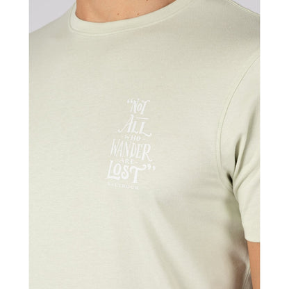 Close-up view of the "Not all who Wander are Lost" print on the front of a men's Saltrock light green Lost Ships t-shirt